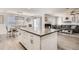 Bright kitchen featuring a large center island and an eat in dining space with views into a cozy living room at 6187 Wescroft Ave, Castle Rock, CO 80104