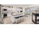 Modern kitchen boasts a large island with seating, stainless steel appliances, and white cabinets for a clean, bright feel at 6187 Wescroft Ave, Castle Rock, CO 80104