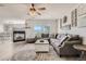 Bright living room featuring a fireplace, large windows, and a comfortable sectional sofa at 6187 Wescroft Ave, Castle Rock, CO 80104