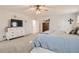 Comfortable main bedroom boasts a dresser with TV, neutral carpet and decor, and a well-lit space for relaxing at 6187 Wescroft Ave, Castle Rock, CO 80104