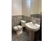 Updated bathroom with pedestal sink and tiled floors at 6397 Ute Hwy, Longmont, CO 80503