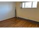 Simple bedroom with hardwood floors and a window at 6397 Ute Hwy, Longmont, CO 80503