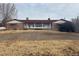 Ranch style home with red roof and stone facade at 6397 Ute Hwy, Longmont, CO 80503