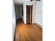 Long hallway with hardwood floors and access to closets at 6397 Ute Hwy, Longmont, CO 80503