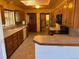 Kitchen with wood cabinets, tile counters, and appliances at 6397 Ute Hwy, Longmont, CO 80503