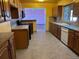 Galley kitchen with wood cabinets and tile floors at 6397 Ute Hwy, Longmont, CO 80503