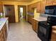 Kitchen with wood cabinets, tile counters and appliances at 6397 Ute Hwy, Longmont, CO 80503