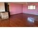 Large living area with hardwood floors and pink walls at 6397 Ute Hwy, Longmont, CO 80503