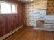 Living room with wood paneling, fireplace and hardwood floors at 6397 Ute Hwy, Longmont, CO 80503