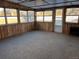 Sunroom with wood paneling, carpet, and windows at 6397 Ute Hwy, Longmont, CO 80503
