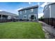 Expansive backyard featuring a lush lawn, a patio area with modern seating, and a privacy fence at 26985 E Bayaud Ave, Aurora, CO 80018