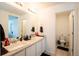 Clean bathroom featuring double sinks with a large mirror and a separate toilet room at 26985 E Bayaud Ave, Aurora, CO 80018