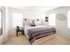 Bright bedroom with light-wood furnishings and decor, and filled with natural light from multiple windows at 26985 E Bayaud Ave, Aurora, CO 80018