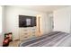 Cozy bedroom features a modern dresser and access to closets and ensuite bath at 26985 E Bayaud Ave, Aurora, CO 80018