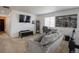 Bright bonus room has a comfy sofa, workspace, and entertainment center, perfect for relaxing at 26985 E Bayaud Ave, Aurora, CO 80018