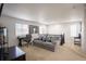Spacious bonus room provides a relaxing space with natural light, desk and modern decor at 26985 E Bayaud Ave, Aurora, CO 80018