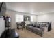 Upstairs bonus room offers a comfortable seating area, desk and natural light from the large window at 26985 E Bayaud Ave, Aurora, CO 80018