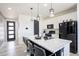Bright kitchen features a center island with barstool seating and sleek, modern appliances at 26985 E Bayaud Ave, Aurora, CO 80018