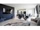 The expansive living room flows into the kitchen, boasting a statement wall and modern decor at 26985 E Bayaud Ave, Aurora, CO 80018