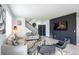 Open-concept living room features modern finishes, including a statement wall, and multiple seating options at 26985 E Bayaud Ave, Aurora, CO 80018
