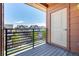 Balcony with black metal railing offering neighborhood views and a closed storage closet at 4100 Albion St # 523, Denver, CO 80216