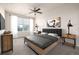 Modern bedroom features a ceiling fan, and large windows with neighborhood views at 4100 Albion St # 523, Denver, CO 80216