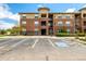 Exterior view of a well-maintained apartment building with accessible parking and landscaped grounds at 4100 Albion St # 523, Denver, CO 80216
