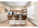 The community kitchen offers a stainless steel refrigerator and oven and granite countertops with barstool seating at 4100 Albion St # 523, Denver, CO 80216
