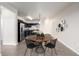 Modern dining area with seating for four and kitchen in the background at 4100 Albion St # 523, Denver, CO 80216
