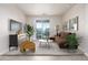 Cozy living room features a comfortable brown sofa and sliding doors to a balcony with neighborhood views at 4100 Albion St # 523, Denver, CO 80216