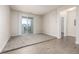 Bright living room with sliding glass doors to a balcony and views of the neighborhood at 4100 Albion St # 523, Denver, CO 80216