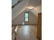 A finished attic space with wood flooring, light, and a window at 219 Colorado Blvd, Idaho Springs, CO 80452