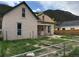 Exterior of the home with green trim, a front porch, and a fenced yard at 219 Colorado Blvd, Idaho Springs, CO 80452