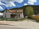 Charming home with a quaint front porch and view of the mountains in the background at 219 Colorado Blvd, Idaho Springs, CO 80452