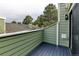 Outdoor balcony with a wood-slat floor and green wood-panel siding at 4108 S Rifle Way, Aurora, CO 80013