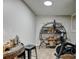 Basement exercise room with a Peloton bike, shelving unit, and space for fitness activities at 4108 S Rifle Way, Aurora, CO 80013