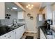Bright kitchen featuring stainless steel appliances, ample counter space and modern lighting at 4108 S Rifle Way, Aurora, CO 80013