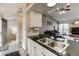 Bright kitchen area with stainless steel sink and modern faucet, adjacent to living space at 4108 S Rifle Way, Aurora, CO 80013