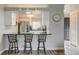 Kitchen view with breakfast bar and stainless steel refrigerator at 4108 S Rifle Way, Aurora, CO 80013