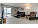 Comfortable living room with sliding doors to the outside, a leather sofa and recliner at 4108 S Rifle Way, Aurora, CO 80013