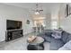 Open-concept living room with vaulted ceiling and a view into the kitchen area at 4108 S Rifle Way, Aurora, CO 80013