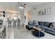 Bright living room with vaulted ceiling offering seamless transition into the kitchen at 4108 S Rifle Way, Aurora, CO 80013
