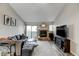 Inviting living room featuring a stone fireplace and sliding glass doors for natural light at 4108 S Rifle Way, Aurora, CO 80013