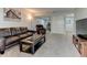 Basement living room featuring a leather sofa and recliner, neutral carpet, and accent lighting at 4108 S Rifle Way, Aurora, CO 80013