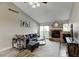 Inviting living room featuring a stone fireplace and access to the outdoor balcony at 4108 S Rifle Way, Aurora, CO 80013