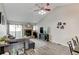 Bright living room with a vaulted ceiling, stone fireplace, and sliding glass doors to the outside at 4108 S Rifle Way, Aurora, CO 80013