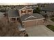 An overhead shot showcasing the home's roof, three-car garage, and neighborhood at 1271 Berganot Trl, Castle Pines, CO 80108