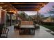 Outdoor living area with comfortable patio seating under a covered deck with string lights at 1271 Berganot Trl, Castle Pines, CO 80108