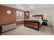 A bedroom with a cozy brown color scheme and large bed near the window at 1271 Berganot Trl, Castle Pines, CO 80108