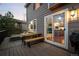 Relaxing backyard deck with comfortable outdoor furniture and view of the outdoor kitchen at 1271 Berganot Trl, Castle Pines, CO 80108